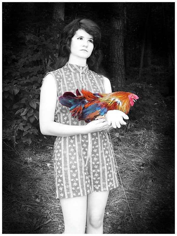 "Autism." My goddaughter has Asperger Autism. She has a gift with animals. She loved holding the rooster and we both liked how the colors of the feathers were an abstract version of the Autism Awareness logo.