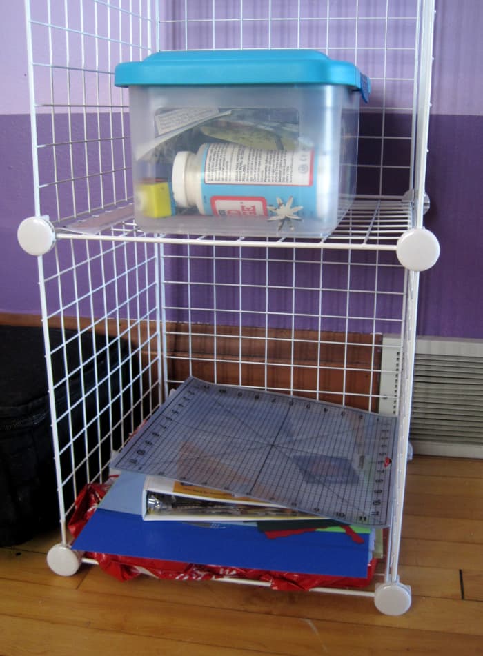 I keep a lot of my scrap book and card making supplies in a container and put larger paper and supplies on another shelf.