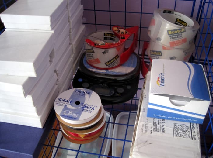 I keep some of my jewelry boxes, postage scale, ribbons, tape, and business cards in one space.