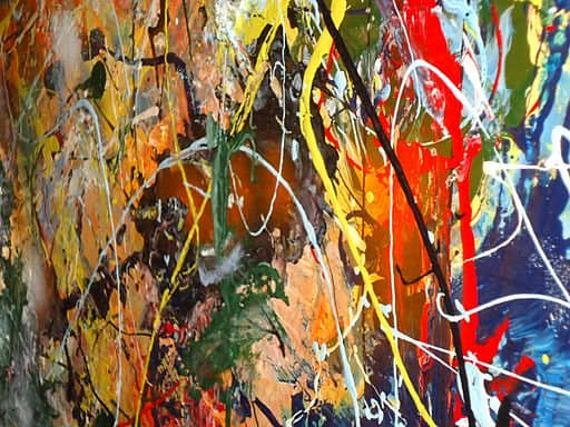 A side view close-up of "drip art" painting entitled 'Tornadoes at Sunset'. The right side is close to the camera so it is somewhat out of focus. The project involved unused paint (which could not be easily recycled).