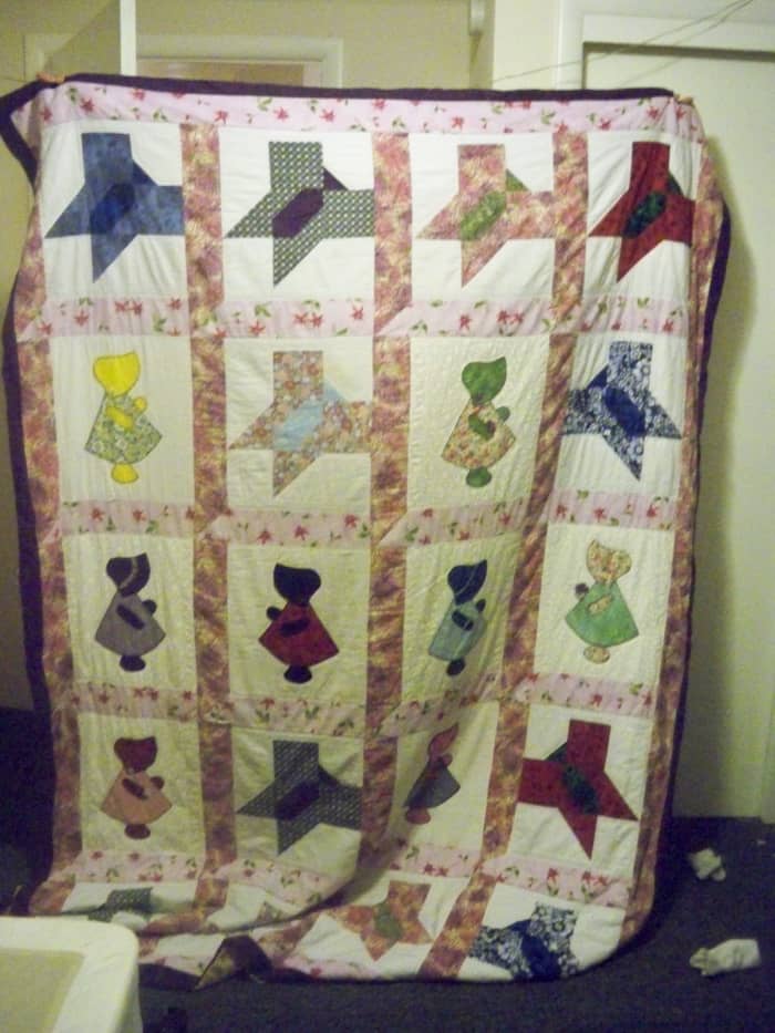 My granddaughter's Sunbonnet Sue and Butterfly quilt. We did the window frame sashing on this quilt. She made the butterfly blocks and I did the Sue blocks. I also hand quilted this whole quilt at her request.