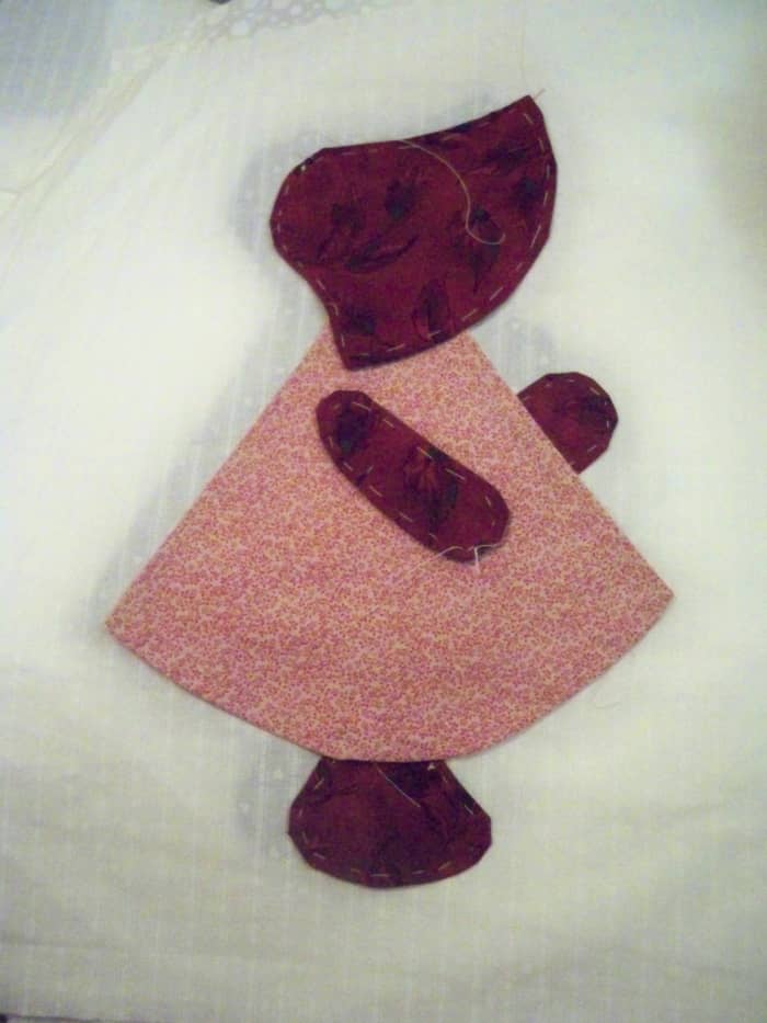 Once she is centered, lift the edges and slide a piece of fusible far enough under so you aren't sewing into it when you do your buttonhole stitches
