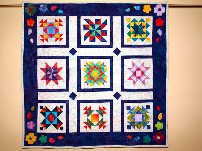 Hand Quilting vs. Machine Quilting—Sampler Quilt using traditional blocks with vibrant modern fabrics.