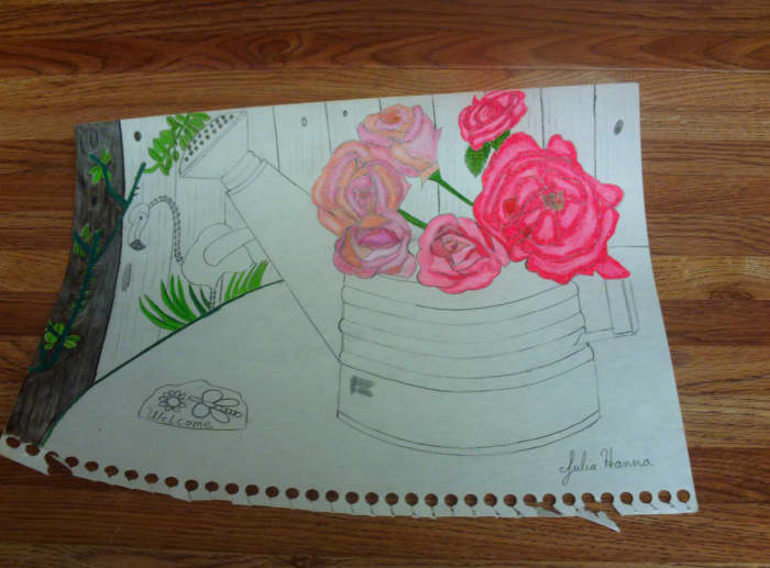 Here I am beginning to color in the first board of the fence behind the roses and flamingo decoration.