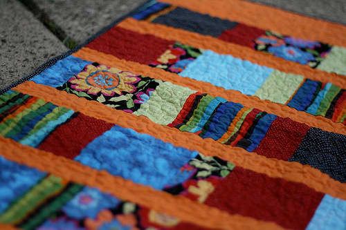 The scrap squares quilt is a type of strip quilt. It uses different lengths of rectangles and is quick and easy for a beginner.