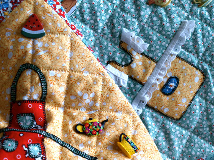 Buttons, lace and decorative hand stitching embellishments add whimsy and character to a quilt, and help tell it's story.