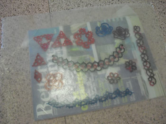 Once stiffener has been applied, arrange pieces, and then cover with a second piece of wax paper.