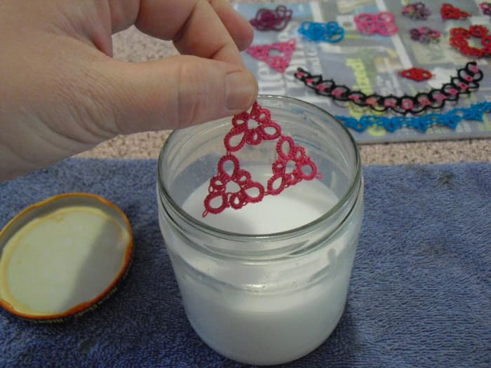 With lazy stiffening, sometimes I just put the lace in a jar of stiffener mix, and shake to apply. Then, I blot on some paper towels before arranging on the magazine to dry.