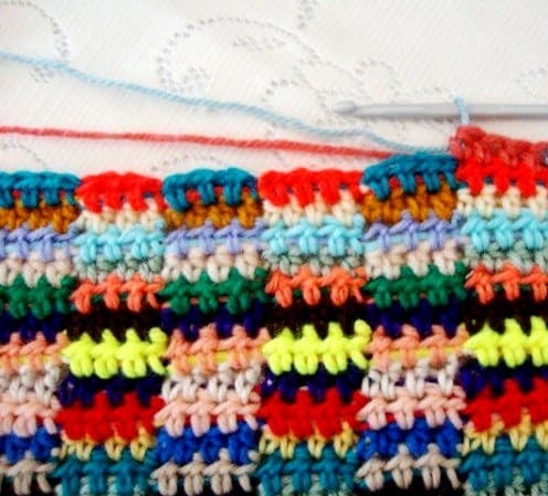 PULLING UP NEXT COLOR--pull next color (blue) through the remaining three stitches of your fourth HDC (rust)