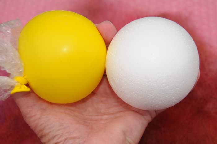 Partially fill the balloon with water and blow it up to the same size as the larger of the two balloons.