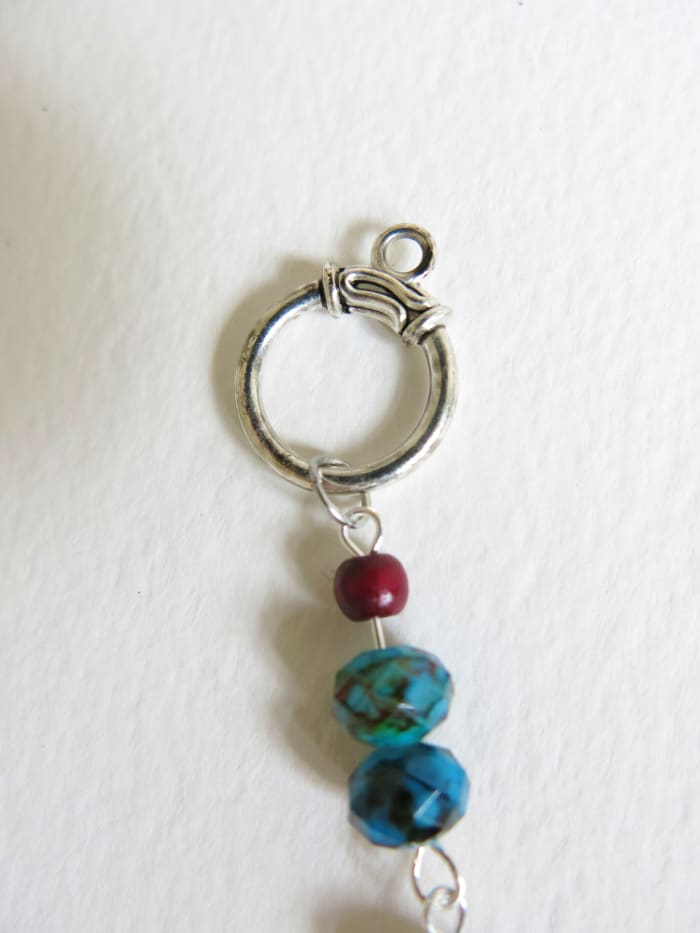 Connect each end of your necklace to one of your linking rings using a jump ring.