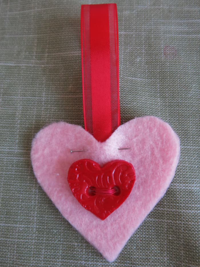 You can add an optional ribbon handle when you sew the front and back pieces of the hearts together.