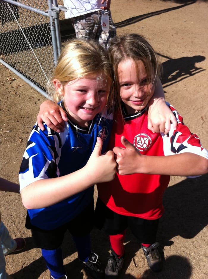 Eight-year-old girls play organized soccer. Give the gift of encouragement.