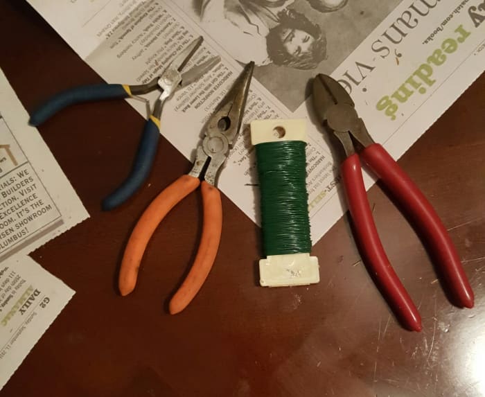You will need needle-nose pliers, wire cutters, and floral wire. I also have a pair of jewelry pliers that were helpful in bending the hangers.