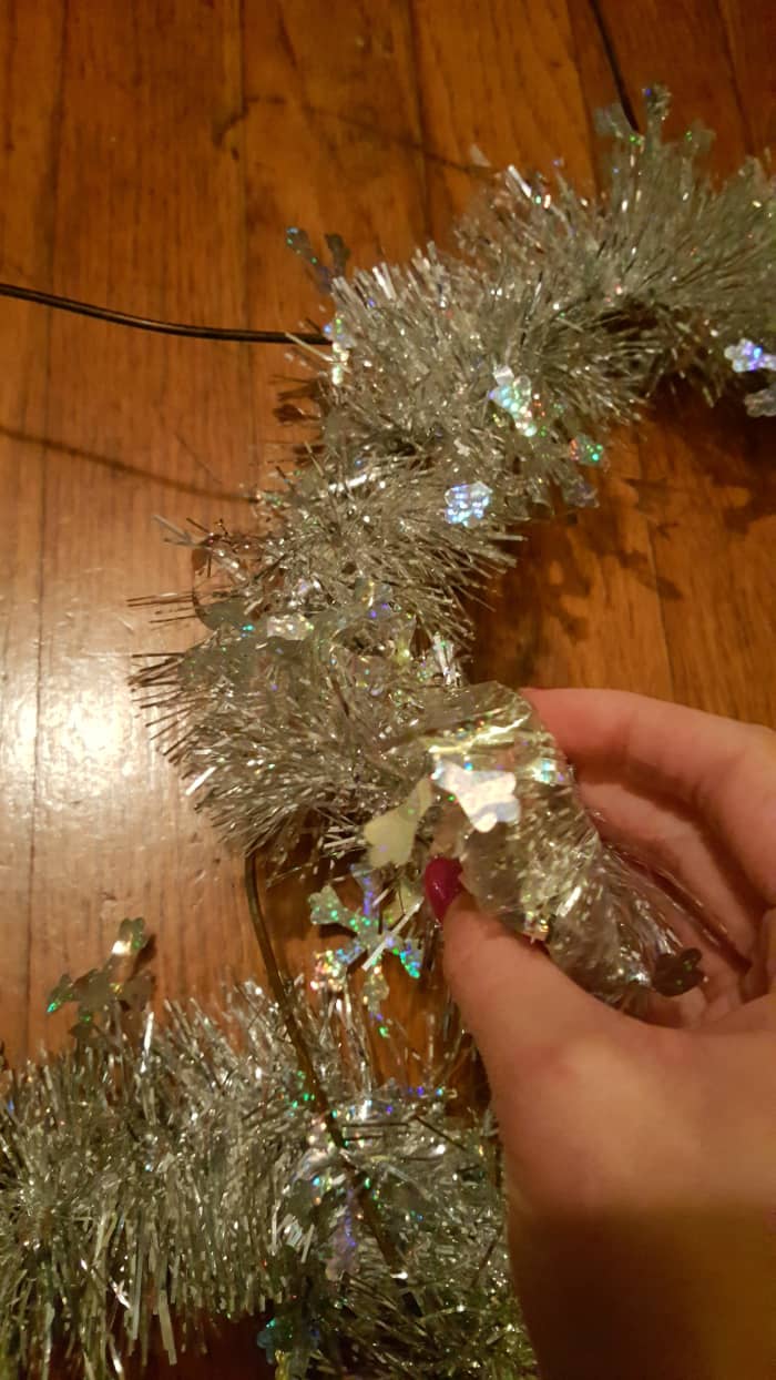 Wrap the garland around the circles to create your snowman body. Continue wrapping until all the wire is covered.