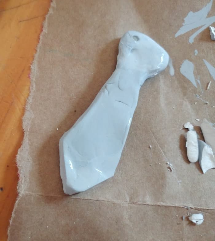 Use Polymer clay to shape the tie. You may use colored Polymer clay to match house color of your choice.