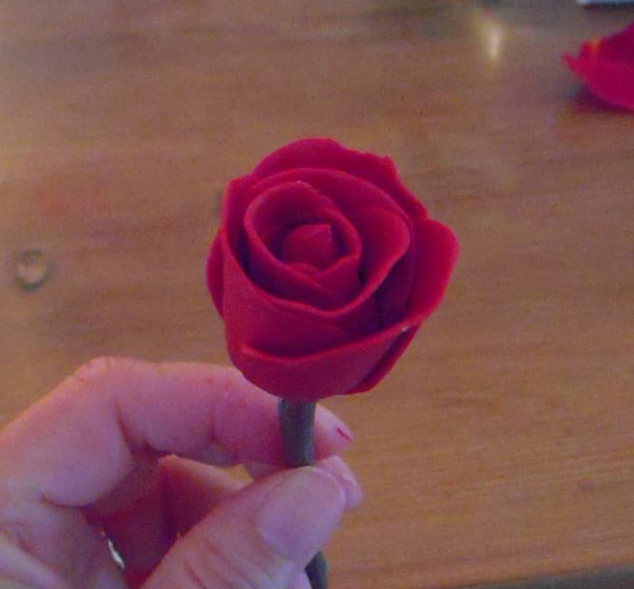 With all petals wrapped, slightly curl outward the edge of last petal so that it looks like the rose is blooming.