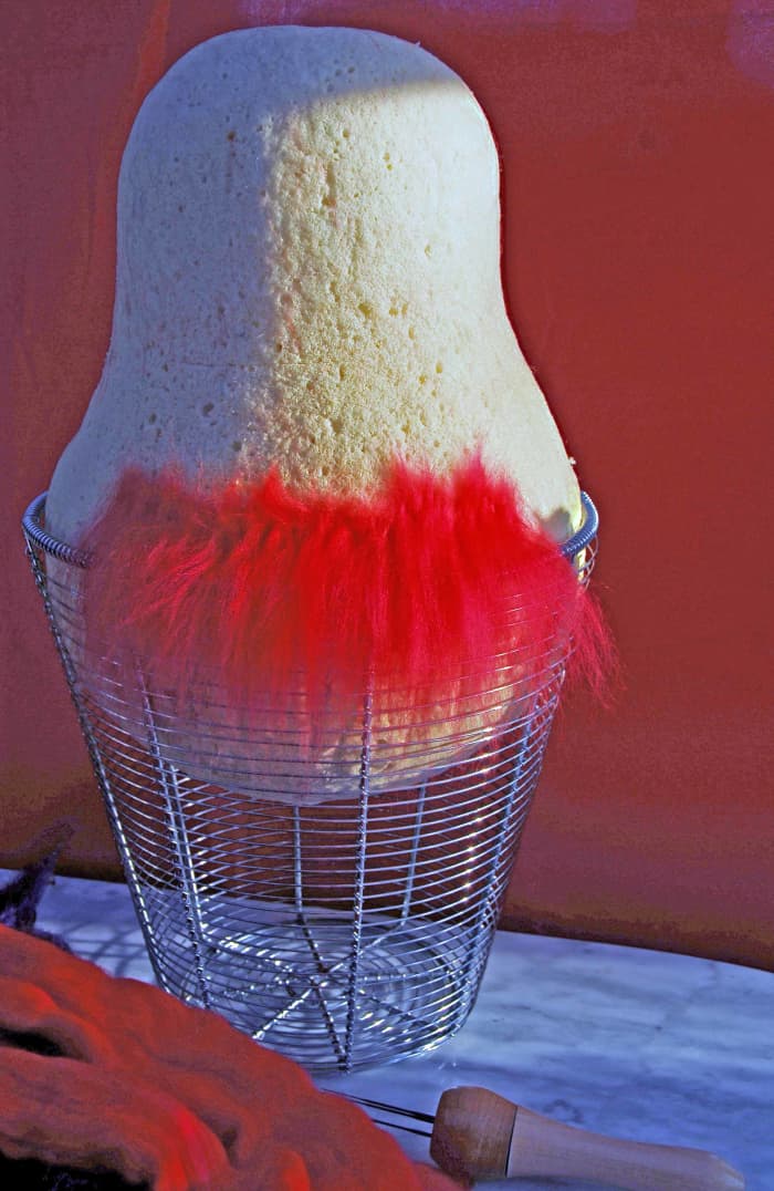 Put down the wool roving starting at the bottom of the mold, working around and upwards.