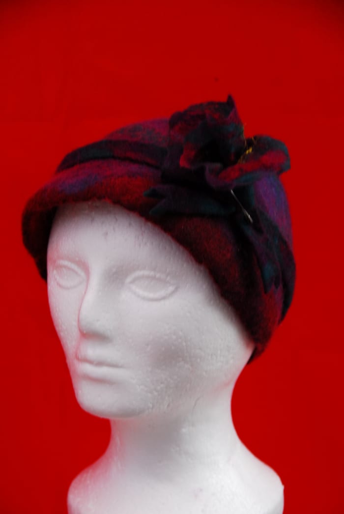 Here is the completed hat along with matching felt flower and hat band; it is still a little wet from shaping.