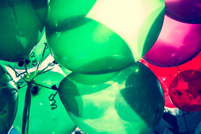 Balloons are a fun and inexpensive decoration. But take care that too many balloons on the floor leads to loud popping and overstimulation. Be mindful this may be upsetting to young toddlers.