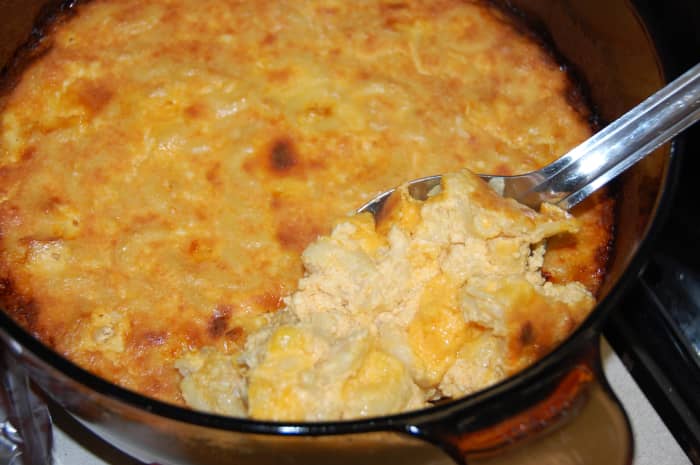Real mac & cheese has milk and eggs and is baked in the oven. Fresh out of the oven, it has a souffle-like texture.