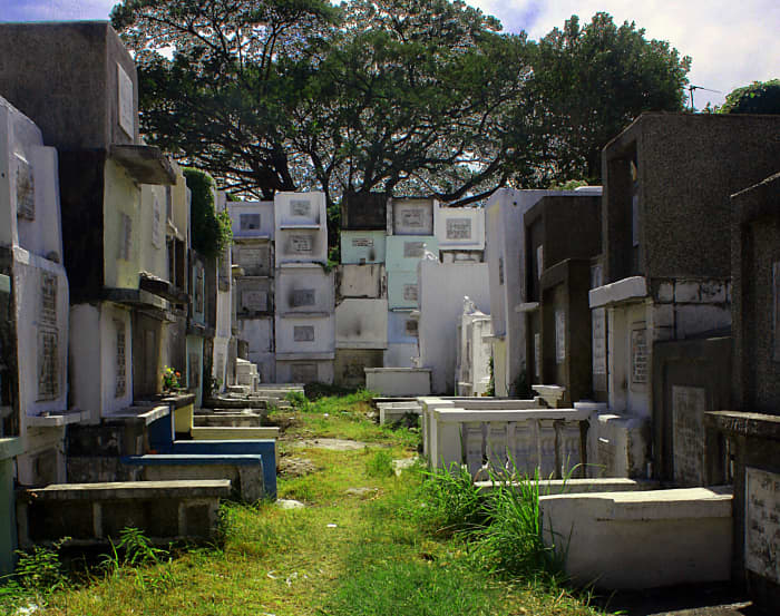 Filipino cemeteries like this one in Santa Rosa, Calabarzon fill with revelers bearing candles and flowers to honor their deceased loved ones on All Saints' Day.