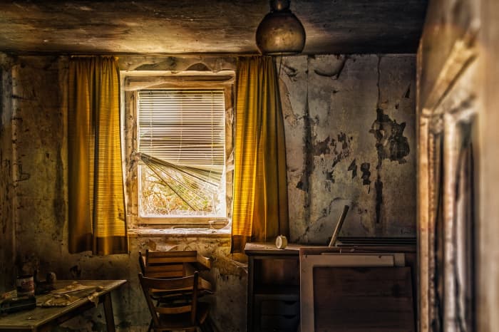 Shabby, long-abandoned rooms are creepy. Have a rat scuttle across the floor and a bat flap across the room.