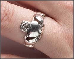 A claddagh ring worn on the left ring finger with the crown pointing to the fingertip shows the wearer is married.