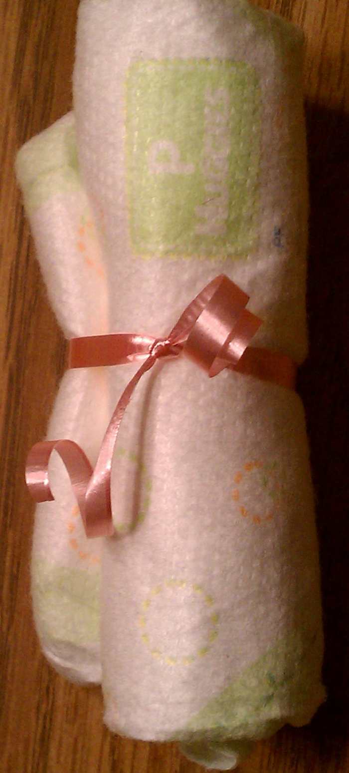 I like this method of securing the diapers because it makes it easy for a mom to just pull a diaper from the cake when she's changing her little one.