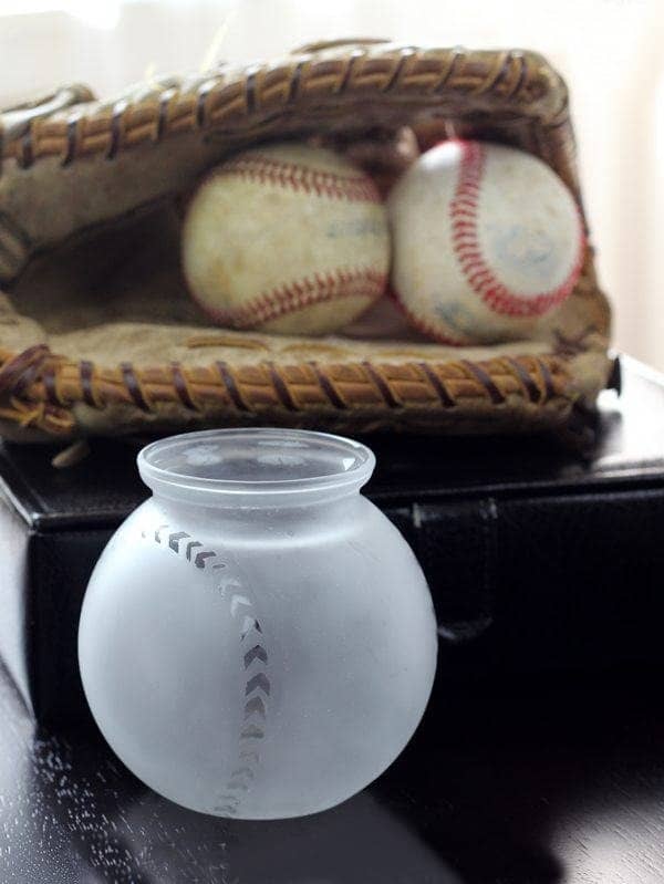 For a sports fan, a homemade baseball-themed storage container can be a nice gift alternative to a baseball hat.