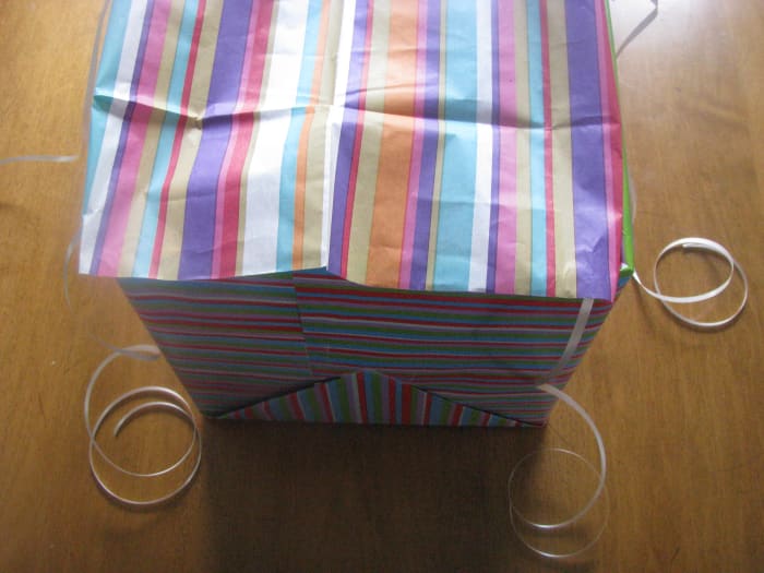 Step Five I tucked the edges of the tissue paper in the box and lightly taped them to the flap of the box.