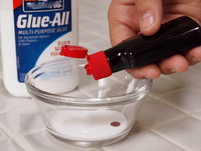 1. Squeeze a dollop of glue into the bowl and add red food coloring. A drop or two of red food coloring will usually do.