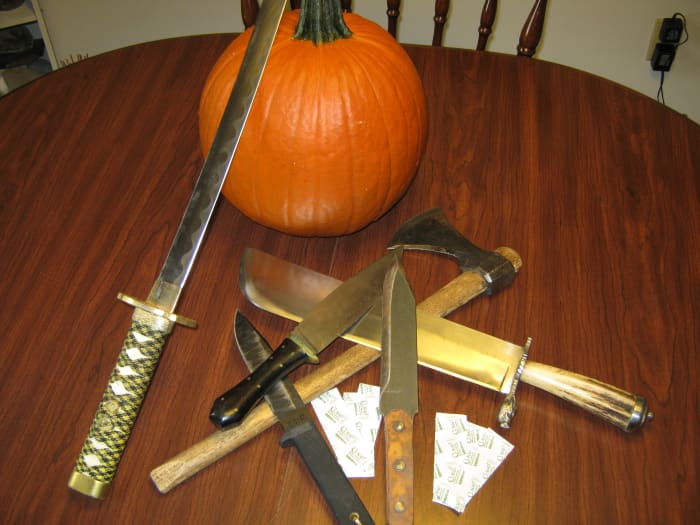 Okay Rambo, put down the pig sticker. Carving a pumpkin isn't an excuse to get out all your edged weapons (unless you are taking pictures for a strange post on hubpages)