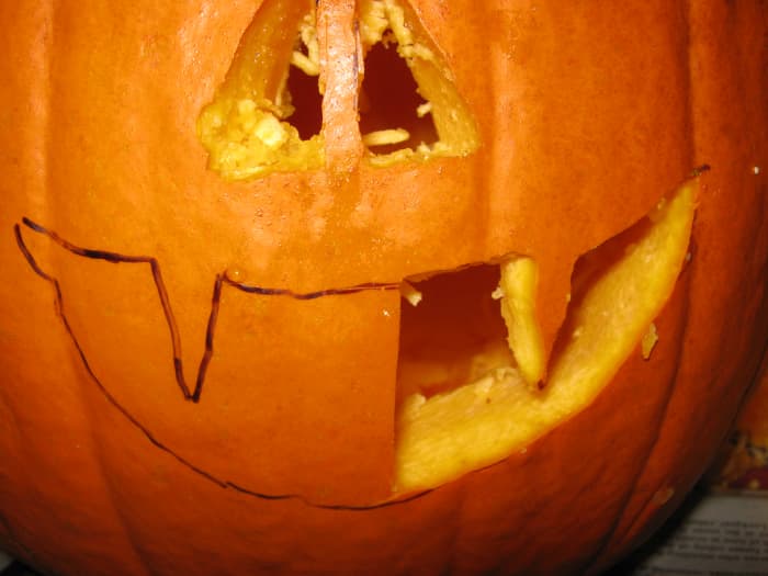 Outline your pumpkin's ghoulish face with a water-soluble marker, then begin chipping away piece by piece. To keep things easy, just carve one large hole in the side of your pumpkin, and claim it is a mouthless cyclops that breathes through its eye.