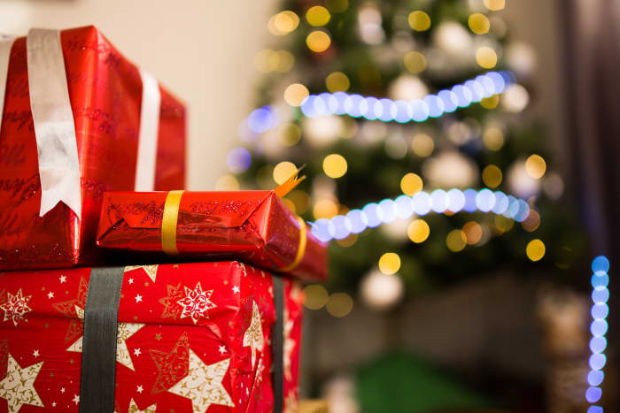 Use a different color ribbon for each person, and don't tell them whose is whose until Christmas Day.