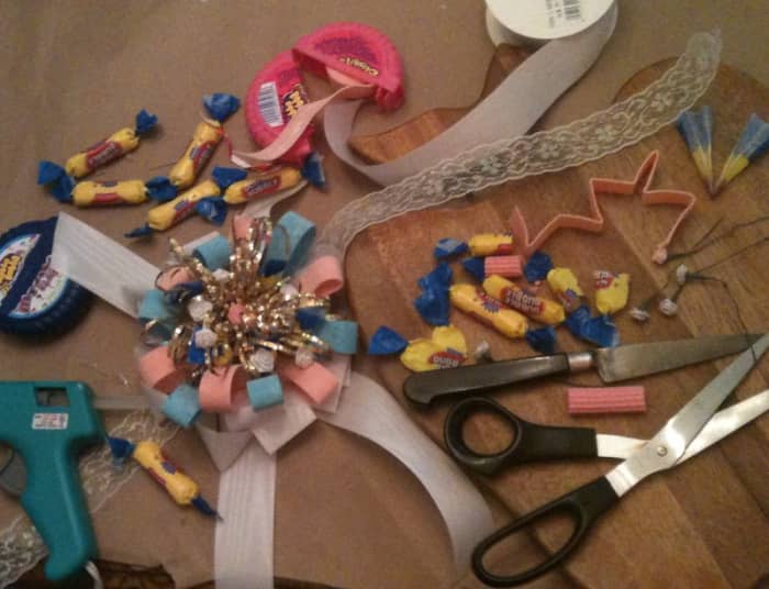 Annemaeve bought fresh bubble gum, but everything else for the corsage came from a box of scrap wrapping paper and ribbons. She assembled the corsage with hot glue and a needle and thread. The blue and pink "ribbons" are bubble gum.
