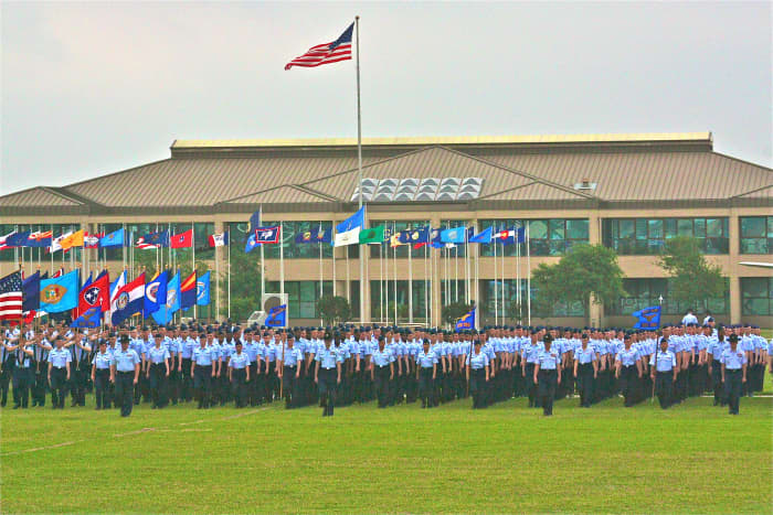 The US flag is on the tallest staff, and is carried in front of state flags by the standard bearers on foot.