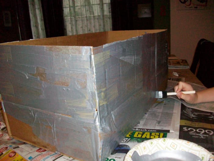 Paint the outside of the box with silver craft paint (or cover the whole thing in aluminum foil).