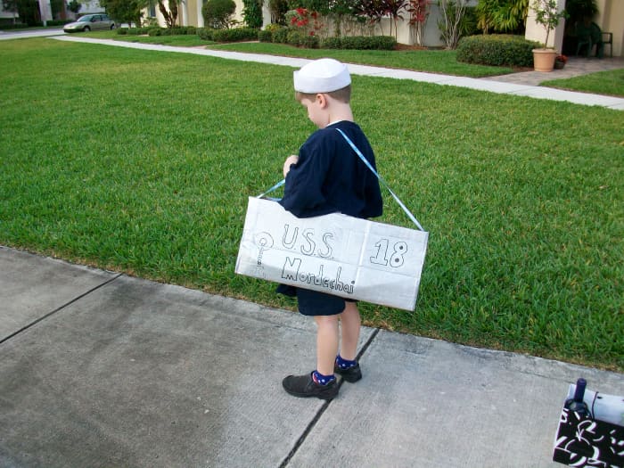 Complete the boat costume with a sailor hat and navy t-shirt, or other nautical accessories you may have around the house.