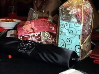Photo 3: Door gifts or party favors wrapped in Indian saree fabric, in line with our Bollywood Dinner Party Theme