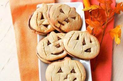 You can cut spooky faces into these pumpkin-shaped cookies, and the filling will peek through to provide a color contrast.