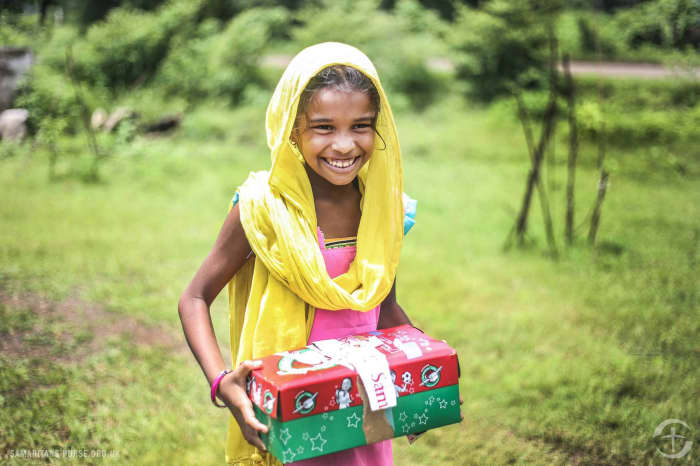 A girl holds her shoebox in Central Asia where access to clean water is limited.