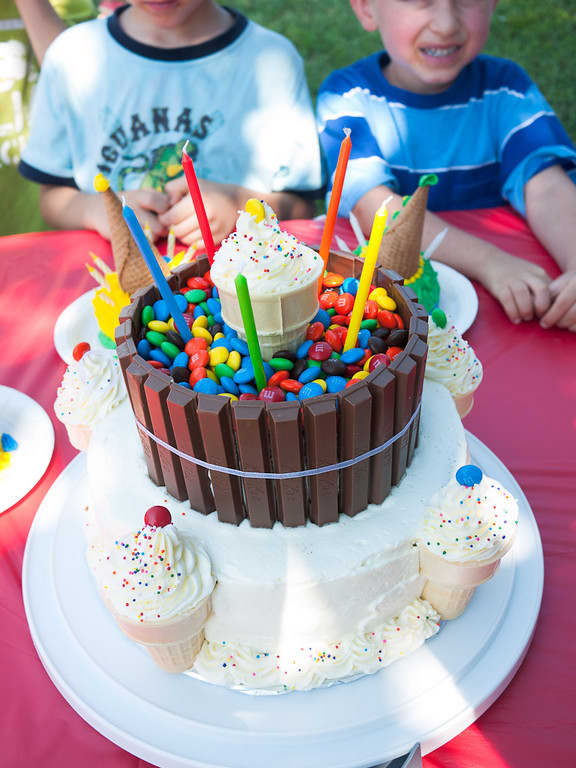 A fun carnival-themed cake, complete with candy barrel and icing ice cream cones!