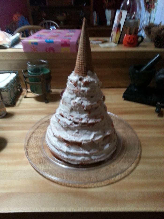This is my cake after a thin layer of frosting. The waffle cone that serves as the tip has yet to be covered.