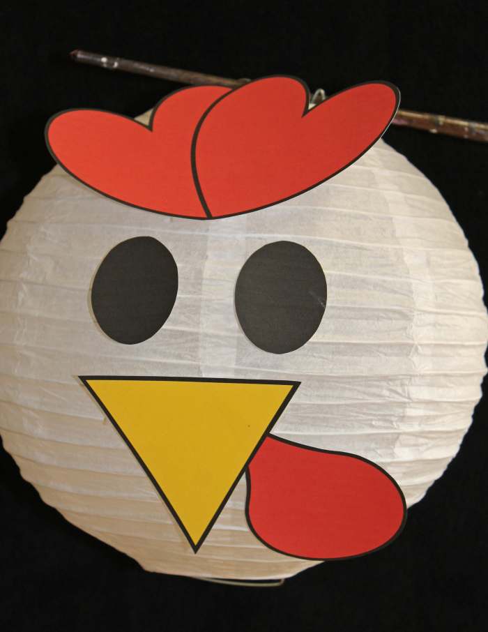 Here is a photo of a purchased paper lantern with rooster facial features. See the templates below that you can print, cut out, and attach to the lantern.