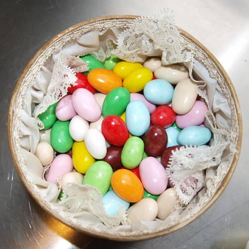 A pretty basket full of green, yellow, orange, blue, white, red, pink, and purple jelly beans. Which color is your favorite?