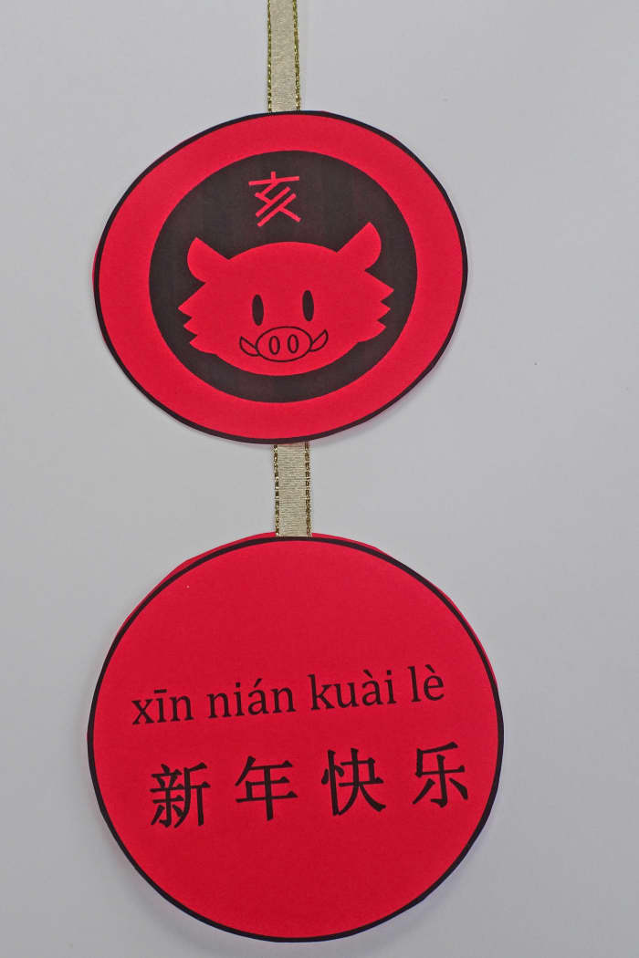 Here is a way to make the ornament. Print the template onto red card stock and attach a ribbon between them.