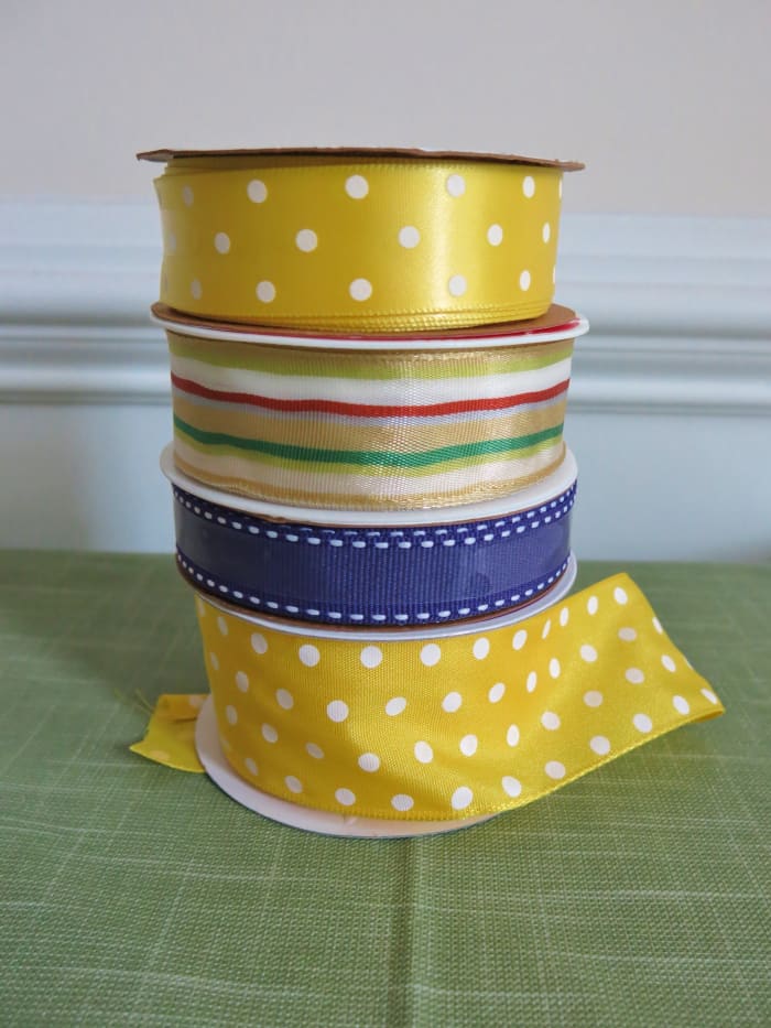 Fabric ribbon is a better choice for making bows for wreaths and anything that will be used outdoors.