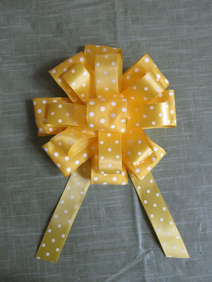 If you would like to add some hanging streamers, cut two or more lengths of ribbon and glue them to the back of your bow.