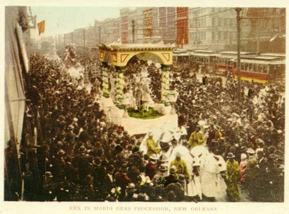This postcard view (approx. 1900) shows a horse-drawn Rex parade float moving down a crowded Canal street.